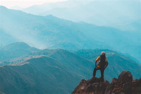 Silhouette Of Man Hold Up Hands On The Peak Of Mountainsuccess Concept