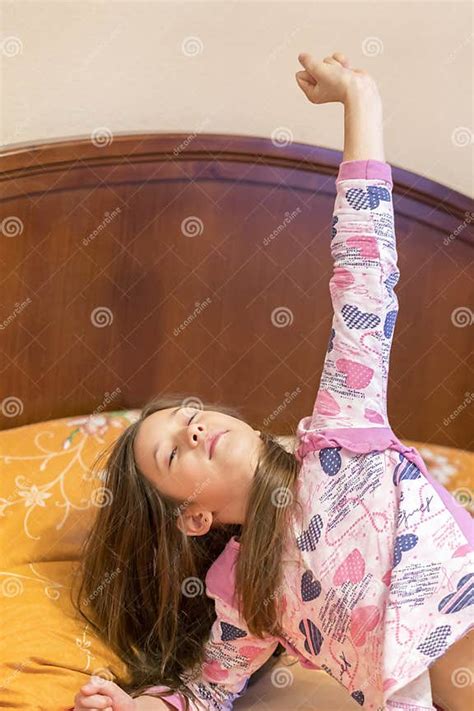 Cute Little Girl Stretching Her Arms Happily With A Smile From Waking