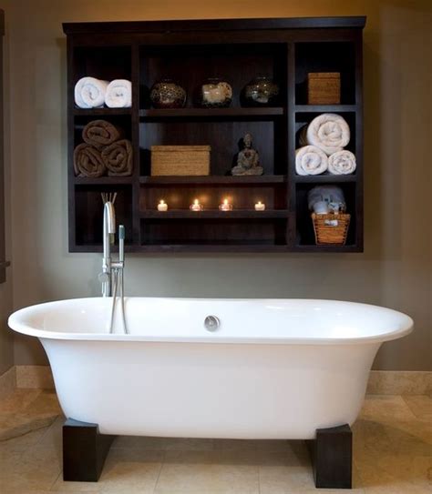 A contemporary outdoor bathroom with an oval tub, tiles and a stone wall. How To Give Your Bathroom A Spa-Like Feel