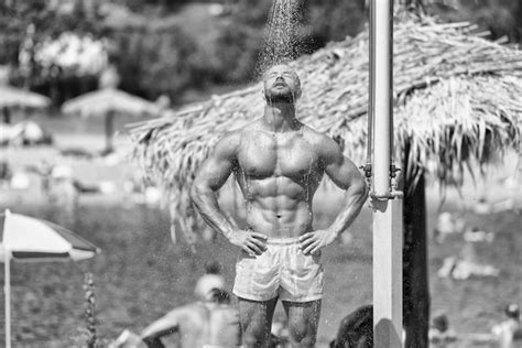 Premium Photo Handsome Muscle Man Takes A Shower Outdoors