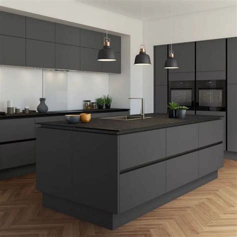 A black stone kitchen with a backsplash, a colorful kitchen island with a stone countertop and pendant lamps. 50 amazing black kitchen design ideas 2020 18 in 2020 ...