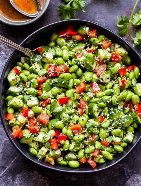 Southwestern cactus salad, recipe, in a medium size mixing bowl, combine cactus, tomatoes, onions, jalapenos and cilantro. Asian Edamame Salad in black serving bowl with spoon in ...