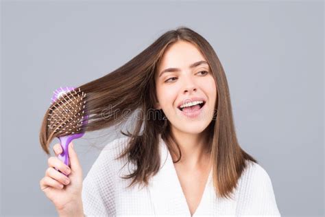 Amazed Woman Combing Hair Portrait Of Female Model With A Comb Brushing Hair Stock Image
