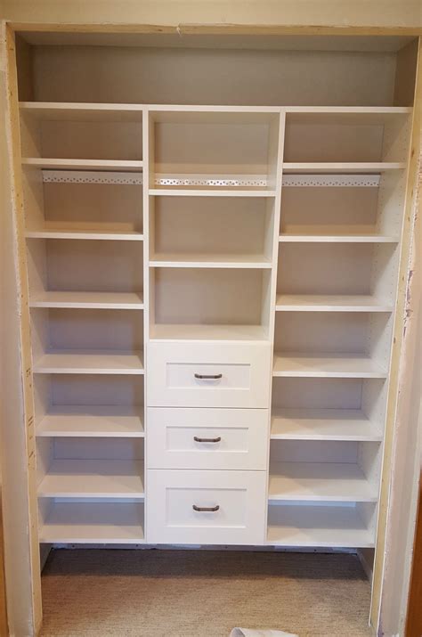 White Melamine Reach In Closet With Adjustable Shelving And Drawers