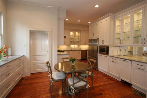 This Kitchen Features A Dinette And Glass Door Cabinets Transitional
