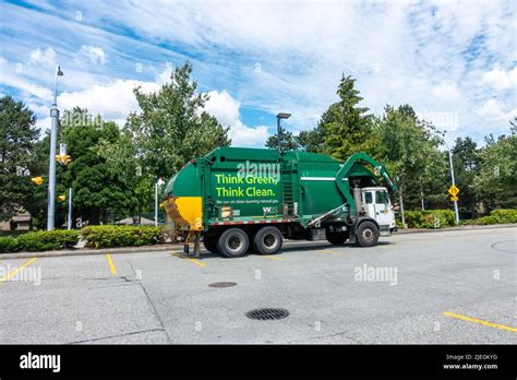 Green Garbage Truck in Surrey Stock Photo - Alamy