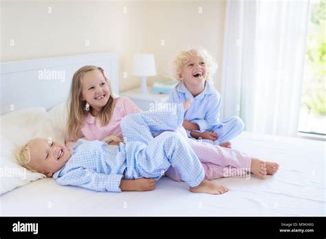 Kids Playing In Parents Bed Children Wake Up In Sunny White Bedroom