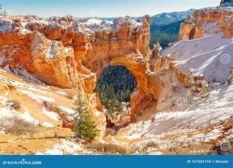 Natural Stone Bridge Arch At Bryce Canyon With Snow Stock Photo