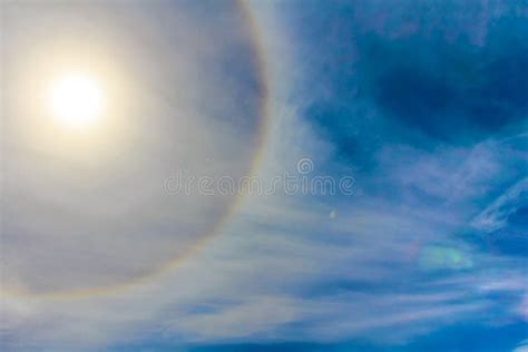 Sun Halo With Clear Blue Sky With White Fluffy Clouds At Noon Day Time