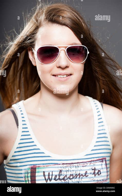 Pretty Brunette Teenage Girl With Sunglasses Studio Shot Stock Photo