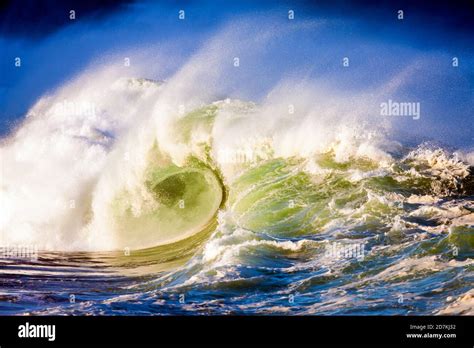 Huge Ocean Wave Violently Breaking At Shore Creating Wall Of Water