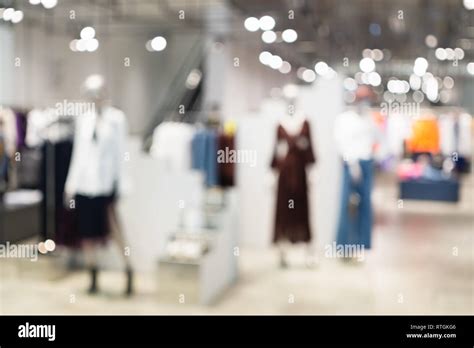 Abstract Blurred Of Fashion Clothes Shop Boutique Interior In Shopping