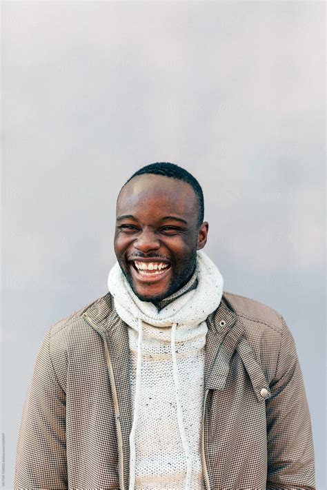 African American Man Smiling Over A White Wall By Stocksy Contributor VICTOR TORRES Stocksy