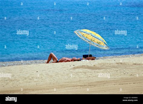 Sunbathers Beside Colourful Umbrella Skala Beach Skala Kefalonia