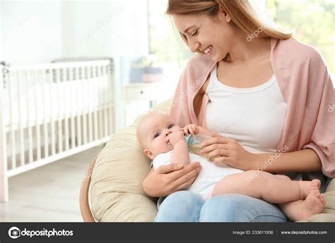 Lovely Mother Giving Her Baby Drink Bottle Room Space Text Stock Photo