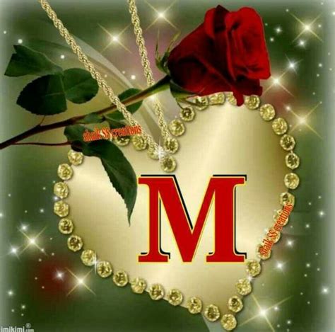 A Heart Shaped Necklace With A Rose On It And The Letter M In The Middle