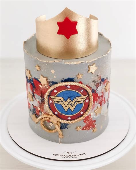 The Cake Is Decorated With Wonder Woman Symbols
