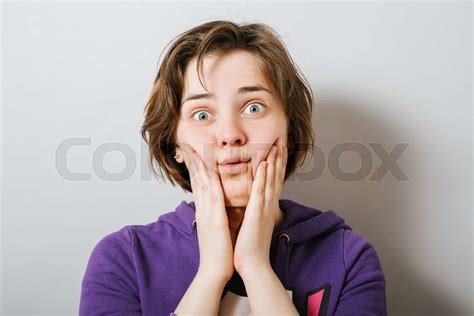 Girl Pushes Fingers To Cheeks Stock Image Colourbox