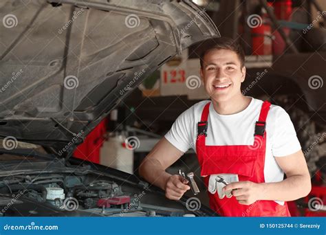 Young Auto Mechanic Repairing Car In Service Center Stock Photo Image