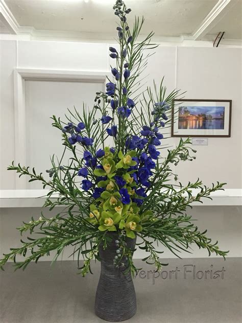 Get deals with coupon and discount code! Unique arrangement of delphinium and cymbidium orchids ...