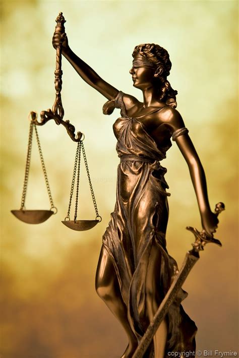 Statue Of Lady Justice Holding Scales Of Justice