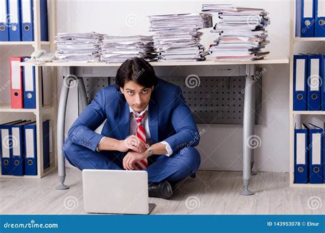 The Young Businessman Employee Unhappy With Excessive Work Stock Photo