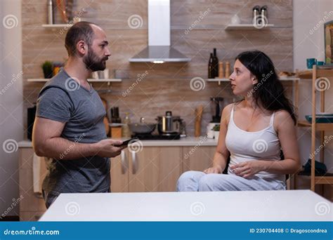 Jealous Husband Watching His Wife Using Mobile Phone Royalty Free Stock