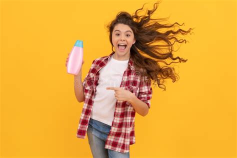 Happy Teen Girl With Long Curly Hair Hold Shampoo Bottle Fun Stock