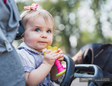Cute Baby Girl Holding Toy In Carriage Outdoors — Innocence Calm