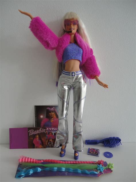 A Barbie Doll Is Posed Next To Some Toothbrushes