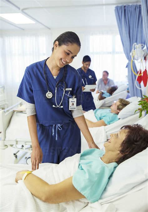Nurse Talking To Patient In Hospital Room Stock Photo