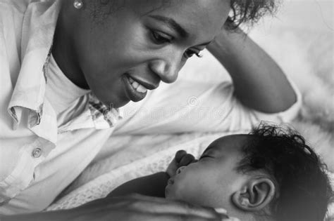 African American Mother Looking At Her Ainfant Baby Son With Love Stock