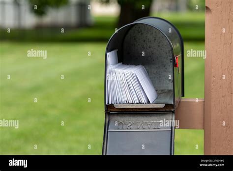 Mailbox full of letters and junk mail. Mail delivery, post office and