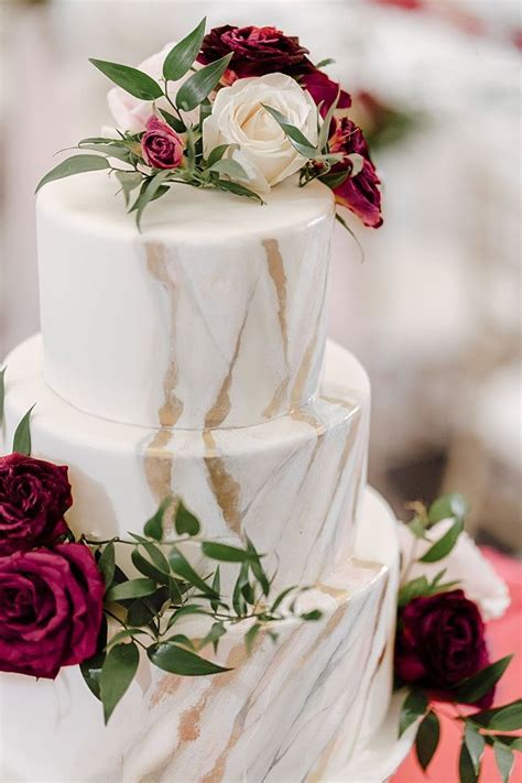 white marbled wedding cake with burgundy and blush flowers madiow photography this timeless