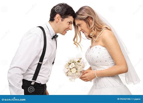 Furious Newlywed Couple Pushing Their Heads Against Each Other Stock