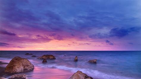 1366x768 Sunset Ocean Water Rock Beach 5k Laptop Hd Hd 4k Wallpapers