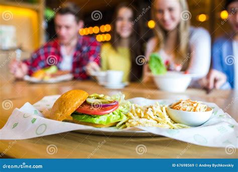 Group Of Young People Having Fun In Cafe Focus On The Meal Stock Image