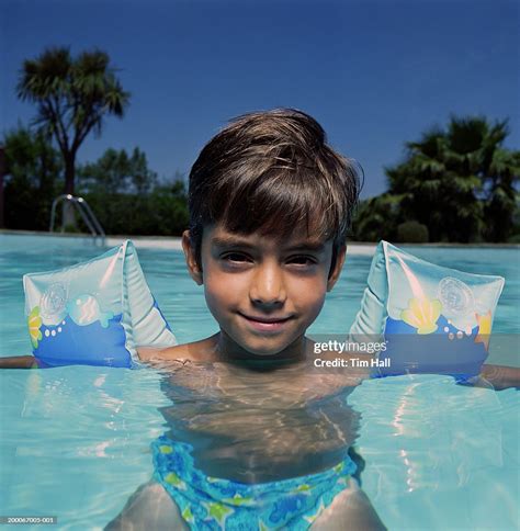 Boy Wearing Armbands In Swimming Pool Portrait High Res Stock Photo
