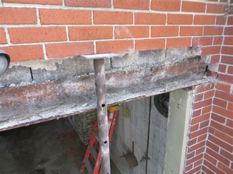 This is hanging from the roof, which means that if you look at the house from the street you can see very faint waviness because the 2x6s supporting the roof that the garage hangs from are unsightly. Garage lintel replacement