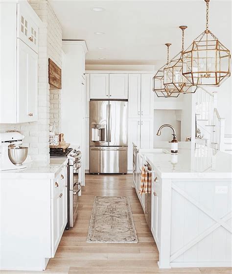 Every piece need not match perfectly; white kitchen with champagne bronze fixtures and brass ...