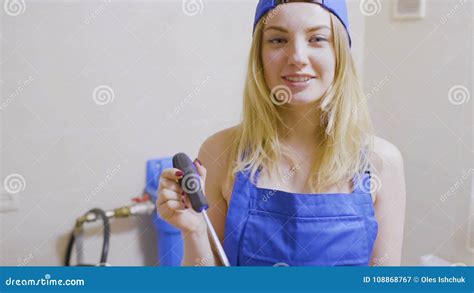 Pretty Girl In Overalls Put Her Screwdriver Into A Pocket Stock Video