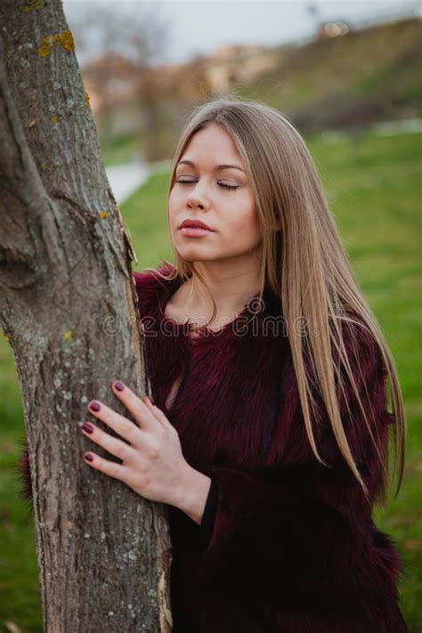 Portrait Blonde Girl Next To A Tree Trunk Stock Photo Image Of Cute