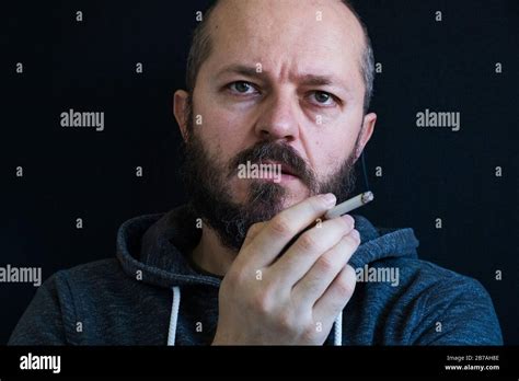 Adult Bearded Man In Hoodie Smoking Cigarette Unhealthy Habit