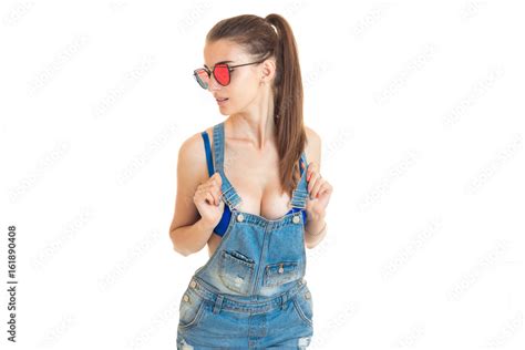 Sexy Girl In Denim Overalls And Blue Bra With Big Silicon Breasts Stock