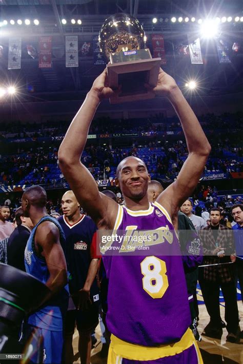 Kobe Bryant Of The Los Angeles Lakers Holds His Trophy Overhead After