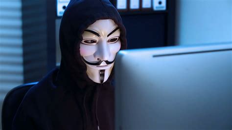 The Hacker In A Mask Of Guy Fawkes Uses The Computer Late At Night
