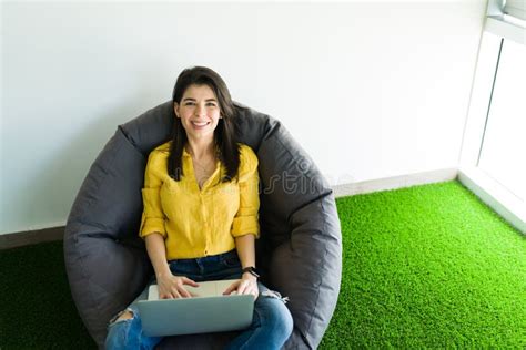 Happy Woman Resting In A Comfortable Chair At Work Stock Photo Image