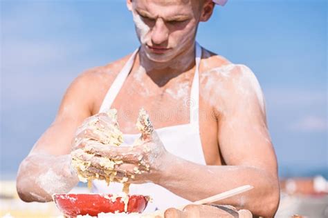 Man Muscular Baker Or Cook Kneading Dough In Bowl Hands Of Chef Cook Covered With Sticky Dough