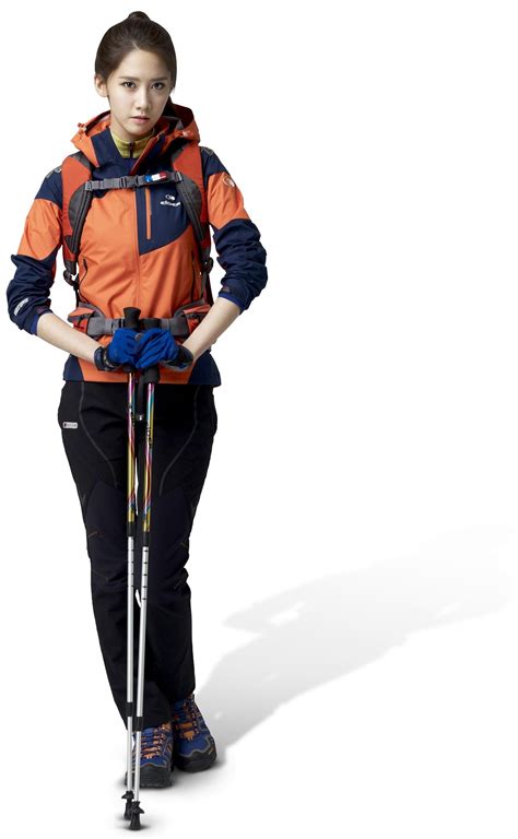 a woman in an orange and blue jacket is holding skis while standing with her hands on the poles