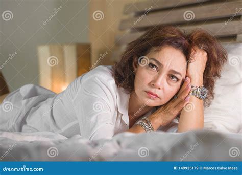 Dramatic Lifestyle Portrait Of Attractive Sad And Depressed Middle Aged Around 50s Woman Feeling